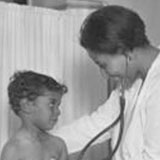 May Edward Chinn examining a young patient, 1930 