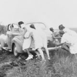 The Mississippi Health Project team pushing their car out of the mud, 1940