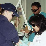 Nancy E. Jasso removing a tattoo from a patient's arm, ca. 2001