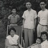 Rebekah Wang-Cheng sitting on her mother's lap along with other family members Ruthie, Ester, John, and her father, ca.1956