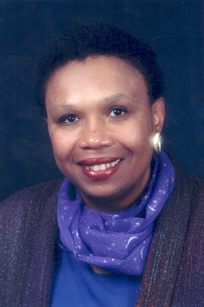 Dr. Vanessa Northington Gamble, an African American woman in a purple scarf smiling for her portrait.