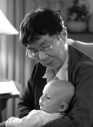 Dr. Mary Elizabeth Dickason King, an elderly woman holding a baby in her arms while seated indoors.