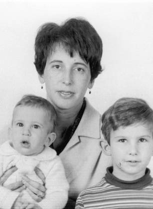 Dr. Katherine M. Detre, a White woman posing with her two children for a portrait.