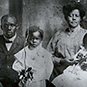 Photo of African American father, mother, and two young sons. Dr. Berry second from left at age 5.