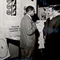 Dr. Berry talking with two men and standing in front of an research display on healing.