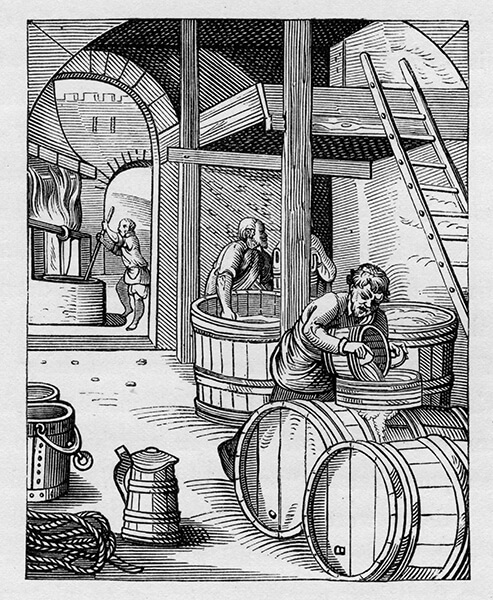 Three men working at large uncovered wood beer vats under a high vaulted structure