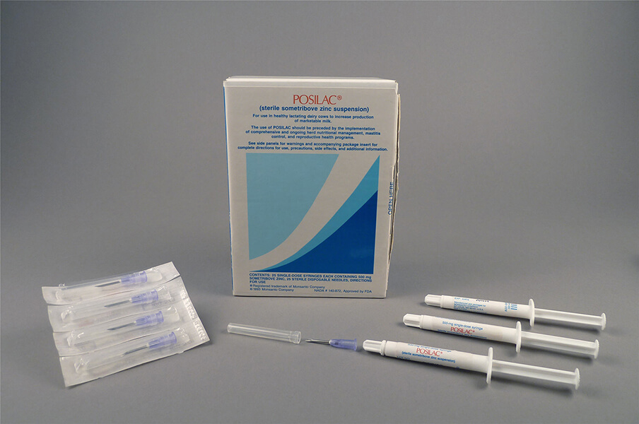 Blue and white box with three white syringes, a needle, and a package of four needles displayed around the box.