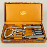 A photograph of a toolbox showing metal medical instruments