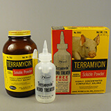 Box, bottle, and plastic dispensing bottle of Terramycin powder with a picture of a pig on the box